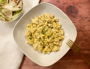 Classic, vegetarian dish, egg with small shapeless dumplings, also known as nockerl or nokedli with iceberg salad and dressing.