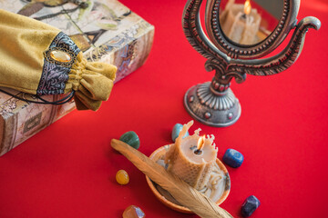 Magical scene, esoteric concept, fortune telling, candle, tarot cards on a table, vintage details	