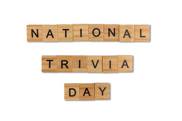 Top view of the word national trivia day day laid out from square wooden tiles isolated on white background. World and international day.