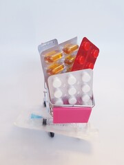 Food cart with pills on white background. Concept of medicine, treatment, use, purchase and sale of medicines.