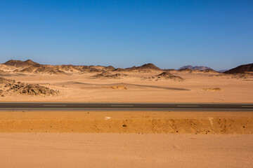 Road in the sahara desert of Egypt. Conceptual for freedom, enjoying the journey. Empty road. Freeway, Highway through the desert