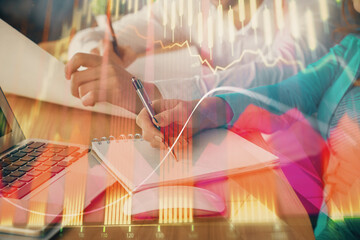 Double exposure of forex chart drawing over people taking notes background. Concept of financial analysis