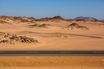 Road in the sahara desert of Egypt. Conceptual for freedom, enjoying the journey. Empty road. Freeway, Highway through the desert