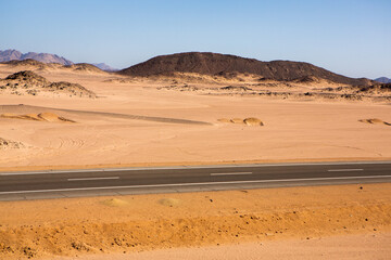 Road in the sahara desert of Egypt. Conceptual for freedom, enjoying the journey. Empty road. Freeway, Highway through the desert
