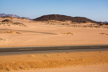 Road in the sahara desert of Egypt. Conceptual for freedom, enjoying the journey. Empty road. Freeway, Highway through the desert