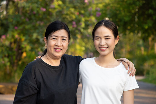 Senior mother staying in the park with asian young adult daughter, healthy lifestyle, family togetherness, mother and daughter, mother day concept