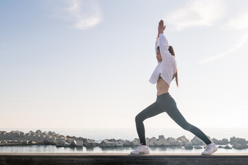 young asian woman practicing yoga in the morning