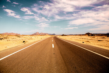 Road in the sahara desert of Egypt. Conceptual for freedom, enjoying the journey. Empty road. Freeway, Highway through the desert