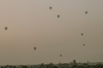 view of a scenic sunrise with many hot air balloons above Bagan in Myanmar. Bagan is an ancient city with thousands of historic buddhist temples.