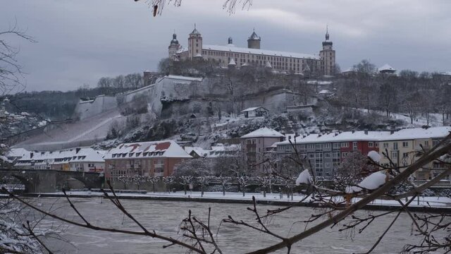 View of the River Main, Festung Marienberg and the Alte Mainbr&uuml;cke on a cold gray winter day in W&uuml;rzburg. This beautiful historical german city is very rarely coverd in snow. Snowfall, cold weather 4K