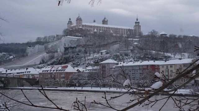 View of the River Main, Festung Marienberg and the Alte Mainbr&uuml;cke on a cold gray winter day in W&uuml;rzburg. This beautiful historical german city is very rarely coverd in snow. Snowfall, cold weather 4K