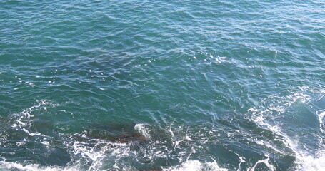 Naklejka premium Beautiful view of stones and waves in the Mediterranean Sea in winter in Israel.