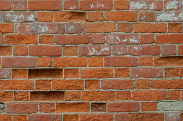 Naklejka premium Old weathered red brick wall for texture or background, classic rough aged brickwork, vintage masonry with cement mortar