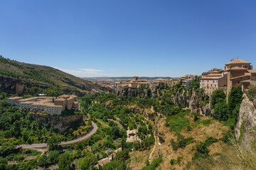 Fototapeta na wymiar River Huécar, Cuenca, Castilla-La Mancha from the top of this UNESCO World Heritage Spanish city in a sunny day. On the left side they are visible the Parador Nacional and the San Pablo bridge.