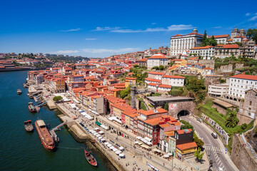 Fototapeta na wymiar Porto, Portugal. August 23,2020. Cityscape. Bairro da Ribeira, iconic neighbourhood seen from high angle on sunlight.