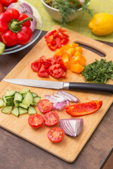 Different vegetables for cooking healthy vegetarian vegan diet food. Cutting vegetable on wooden board on kitchen