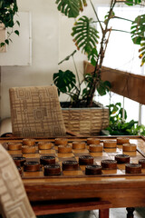 Recreation area with checkers on the table and indoor plants.Home gardening.Houseplants and urban jungle concept.Biophilia design.Selective focus with shallow depth of field.