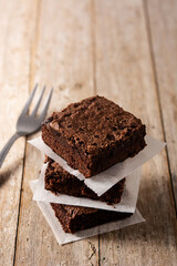 Homemade pieces of brownies on wooden table	