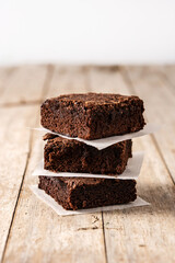 Homemade pieces of brownies on wooden table	