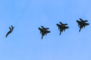 American military air force fighter jets in the sky in formation flight seen from below