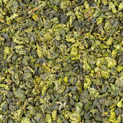 Dry green oolong tea leaves texture background