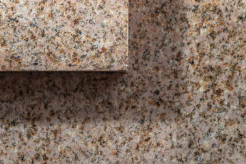 Smooth cut of the stone. Polished pink granite texture. Two layers of stone with shadow.