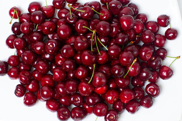a full plate of juicy and ripe cherries. view from above