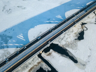 One metro train travels along the Kiev metro bridge. A shadow falls on the frozen Dnieper River....