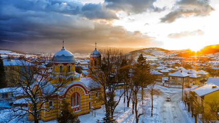 Small village in Bulgaria drone picture. Sunset time. Orthodox church in foreground.