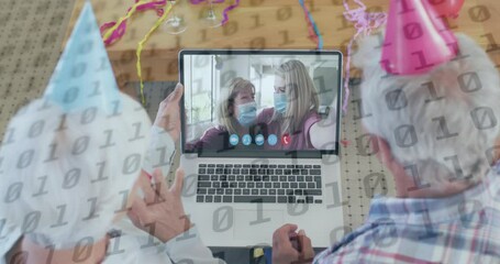 Animation of binary coding numbers over senior couple using laptop on video call - Powered by Adobe