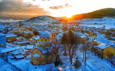 Small village in Bulgaria drone picture. Sunset time. Orthodox church in foreground.