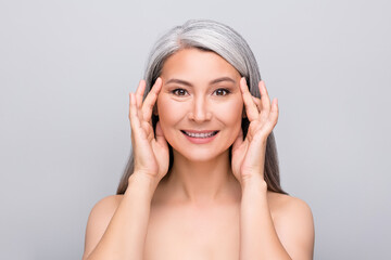 Photo of flawless beautiful healthy pensioner lady arms touch face temples white smile isolated...