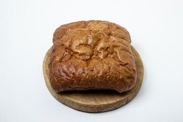 Black bread on a white background. Borodino bread. Homemade baking. Bakery product