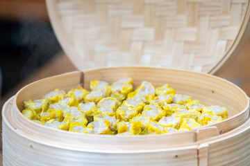 Dim Sim (Kanom jeeb) the chinese steamed dumpling on banana leaf in bamboo wicker plate for appetizer of seminar.