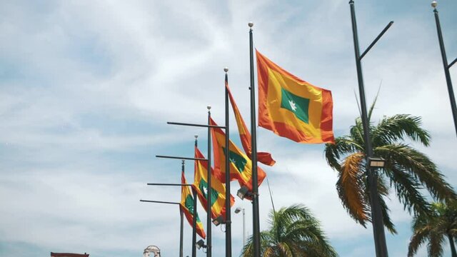 Cartagena waving flags in slow-motions during a windy day in Colombia, South America