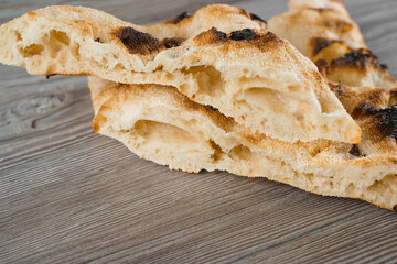 Dough for pinsa romana and scrocchiarella gourmet italian cuisine on grey wooden background. Traditional dish. Food delivery from pizzeria