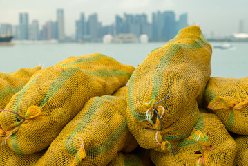 Fresh potatoes in bags, waiting for loading at the port of Singapore.