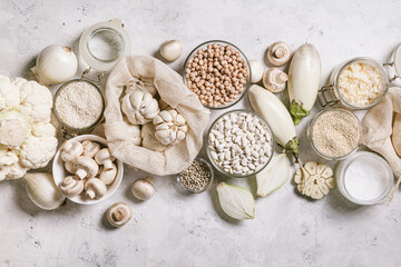 White vegetables and mushrooms, rice, quinoa, legumes, white peppercorns, coconut oil on a white background. Healthy eating and the concept of clean eating.
