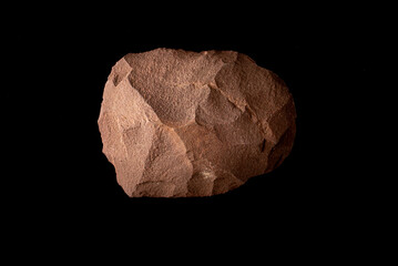 Beautiful paleolithic quartzite splitter very well preserved on a black background