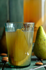 Homemade compote with pears on a wooden background