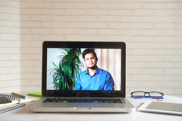 Businessman In a video conference display on laptop screen 