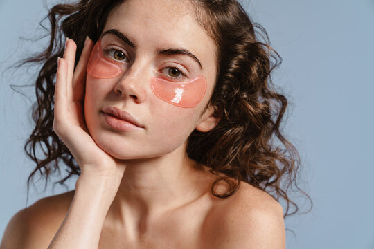 Beautiful half-naked nice girl posing with eye patches