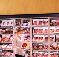 supermarket shopping, face mask and gloves,Woman choosing a dairy products at supermarket