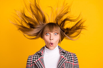 Portrait of carefree girl flying hair open mouth staring camera wear checkered isolated on yellow color background