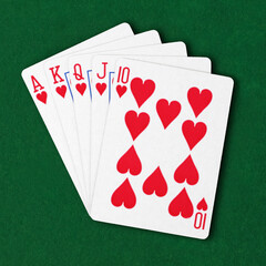 Royal flush in hearts on green card table winning hand business concept