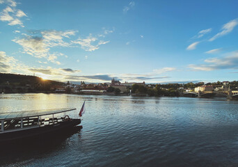 Boat on Vltava during sunset