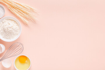 Ingredients for baking on light pink background.