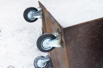 The new wheels are welded to the old garbage can