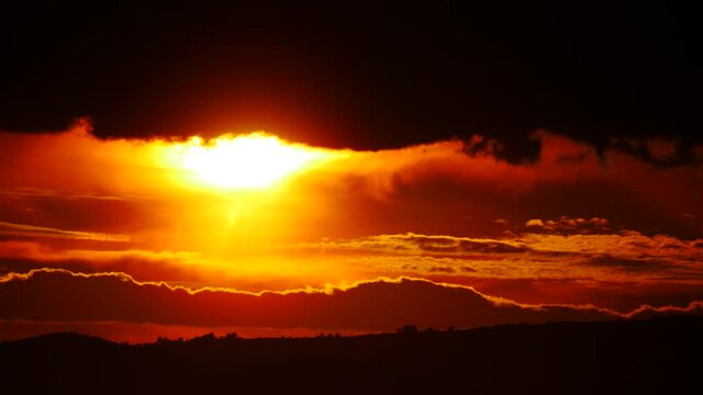 Skyscape. Burning sky, dark stormy clouds. Red orange color sunset over sea. Nature, coastal landscape. Capi Corb, Mediterranean coast of Spain.