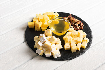 Nuts, cheese and honey on plate. Cheese plate